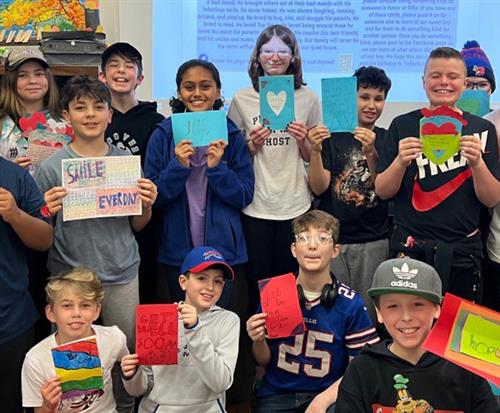 Students holding cards